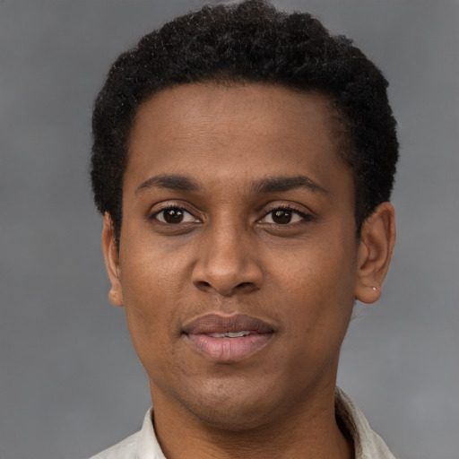 Joyful black young-adult male with short  brown hair and brown eyes