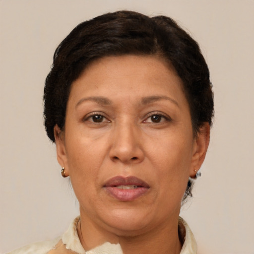 Joyful latino adult female with short  brown hair and brown eyes