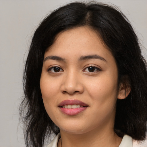 Joyful asian young-adult female with long  brown hair and brown eyes