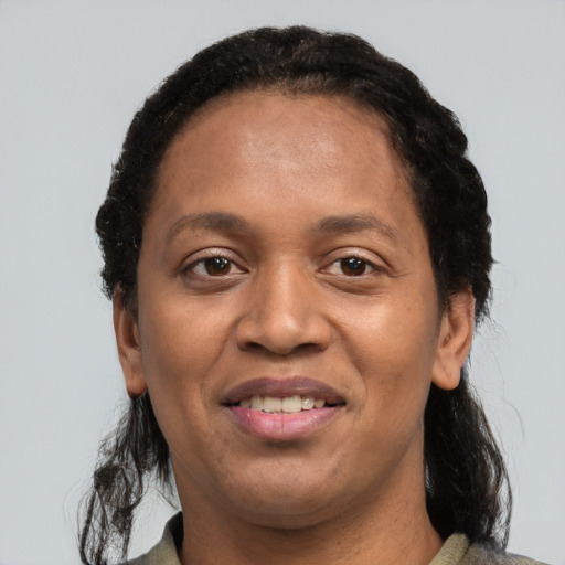 Joyful black adult female with short  brown hair and brown eyes