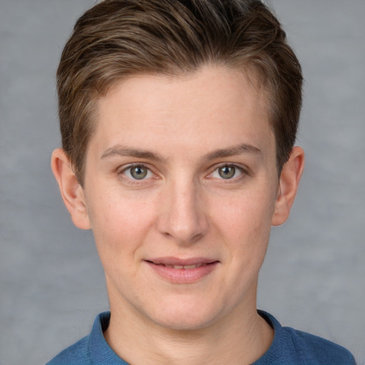 Joyful white young-adult female with short  brown hair and grey eyes