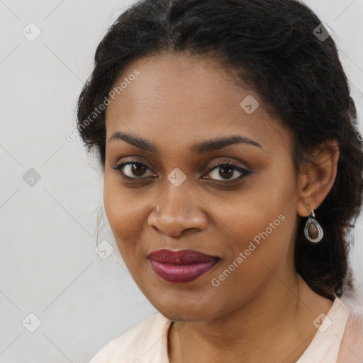 Joyful black young-adult female with long  brown hair and brown eyes