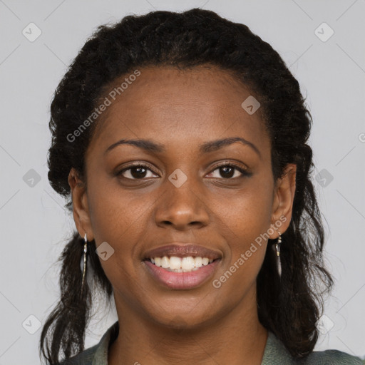 Joyful black young-adult female with long  black hair and brown eyes