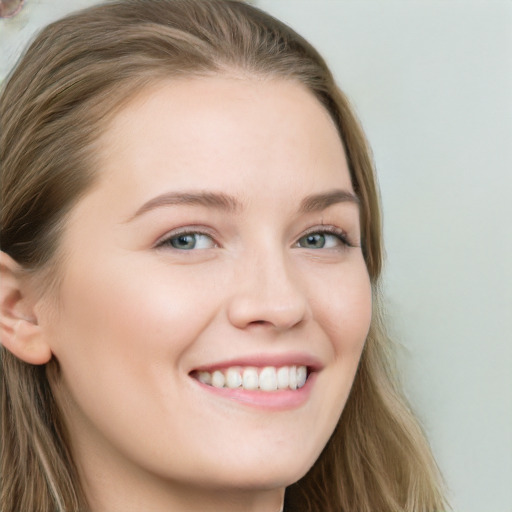 Joyful white young-adult female with long  brown hair and blue eyes