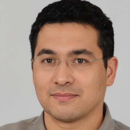 Joyful asian young-adult male with short  black hair and brown eyes