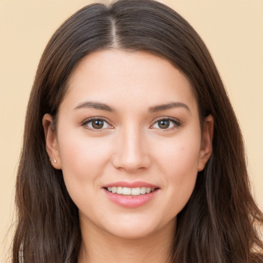 Joyful white young-adult female with long  brown hair and brown eyes