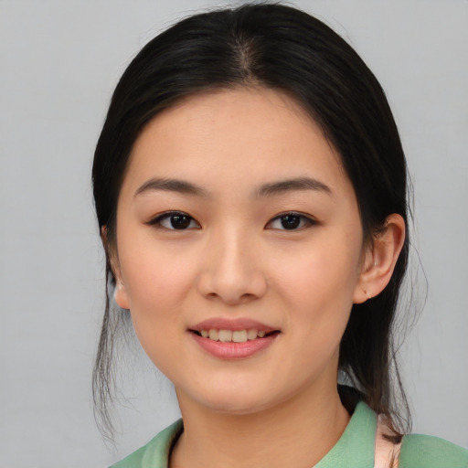 Joyful white young-adult female with medium  black hair and brown eyes