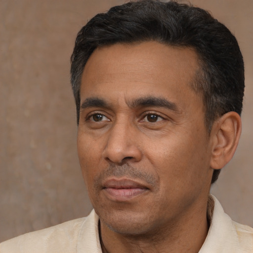 Neutral latino adult male with short  black hair and brown eyes