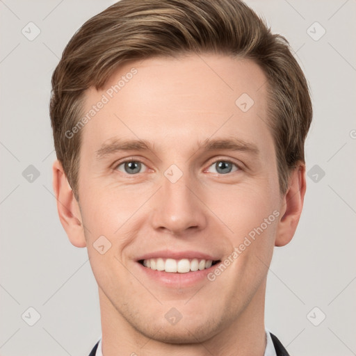 Joyful white young-adult male with short  brown hair and grey eyes