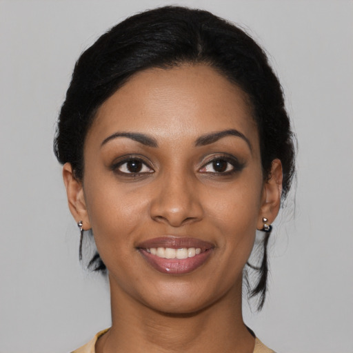 Joyful latino young-adult female with medium  black hair and brown eyes