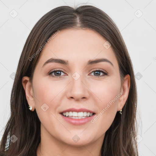 Joyful white young-adult female with long  brown hair and grey eyes