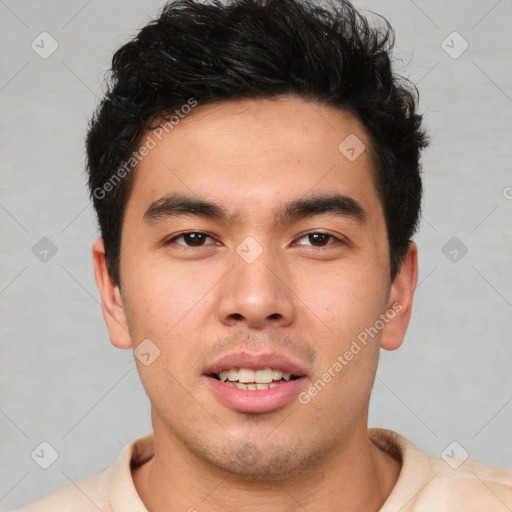 Joyful latino young-adult male with short  brown hair and brown eyes