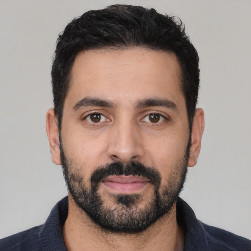 Neutral latino young-adult male with short  black hair and brown eyes