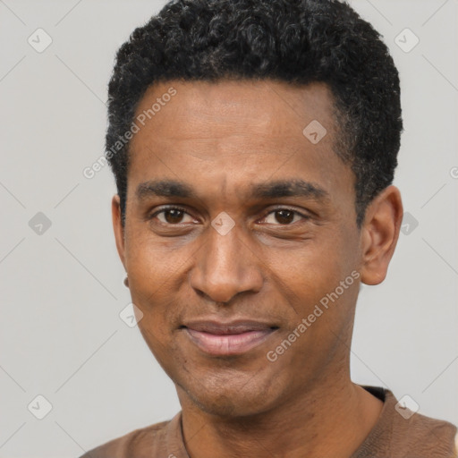 Joyful black adult male with short  black hair and brown eyes
