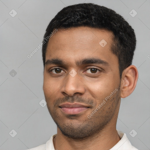 Joyful black young-adult male with short  black hair and brown eyes