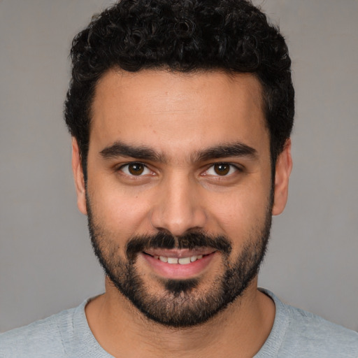 Joyful white young-adult male with short  black hair and brown eyes