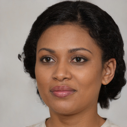 Joyful black young-adult female with medium  black hair and brown eyes