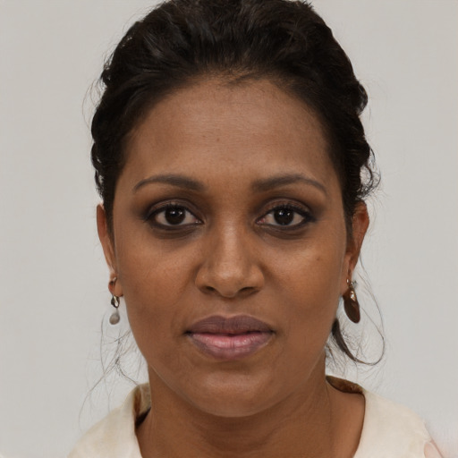 Joyful black young-adult female with medium  brown hair and brown eyes