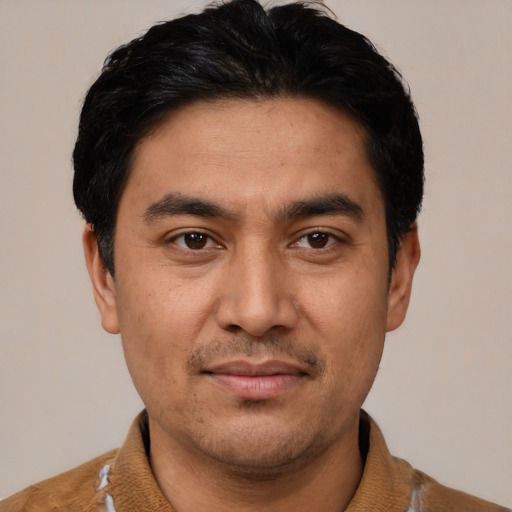 Joyful latino young-adult male with short  black hair and brown eyes
