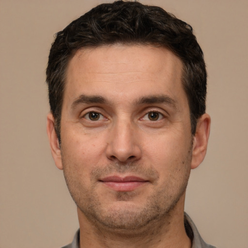 Joyful white adult male with short  brown hair and brown eyes