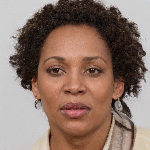 Joyful black adult female with short  brown hair and brown eyes