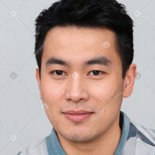 Joyful asian young-adult male with short  black hair and brown eyes