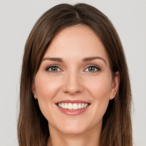 Joyful white young-adult female with long  brown hair and brown eyes