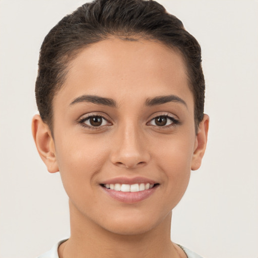 Joyful white young-adult female with short  brown hair and brown eyes