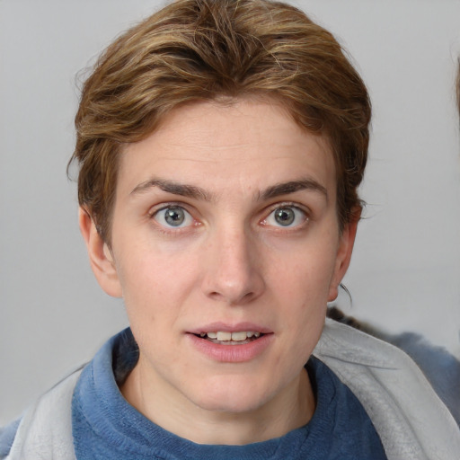 Joyful white young-adult female with medium  brown hair and blue eyes