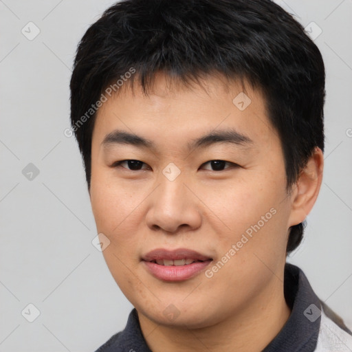 Joyful asian young-adult male with short  black hair and brown eyes