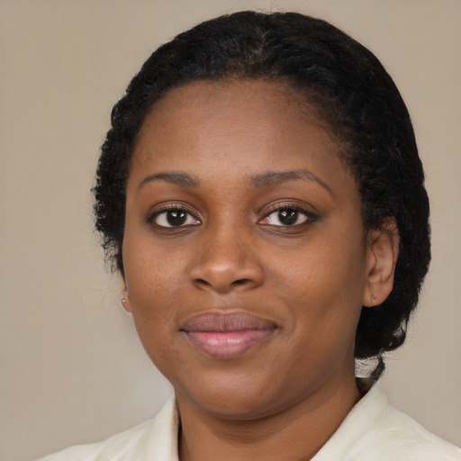 Joyful black young-adult female with short  black hair and brown eyes