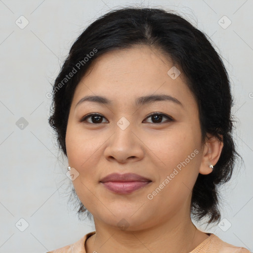 Joyful latino young-adult female with medium  brown hair and brown eyes