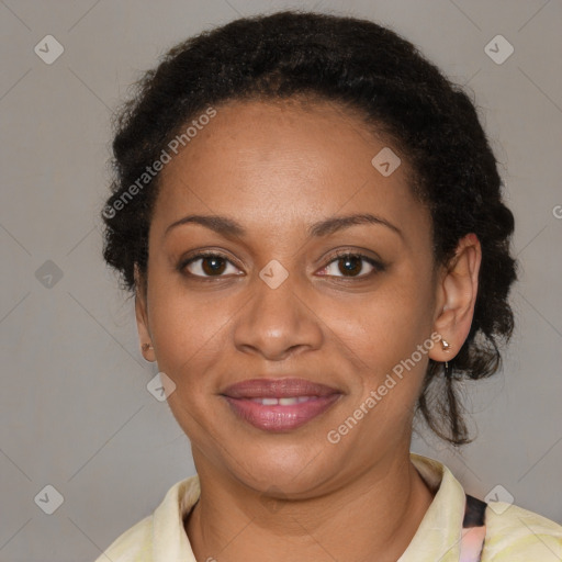 Joyful black adult female with medium  brown hair and brown eyes