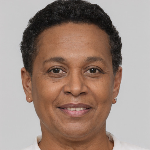 Joyful black adult female with short  brown hair and brown eyes
