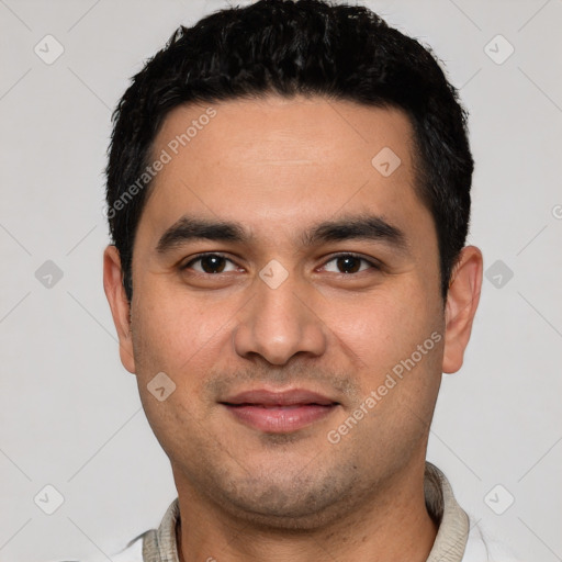 Joyful white young-adult male with short  black hair and brown eyes