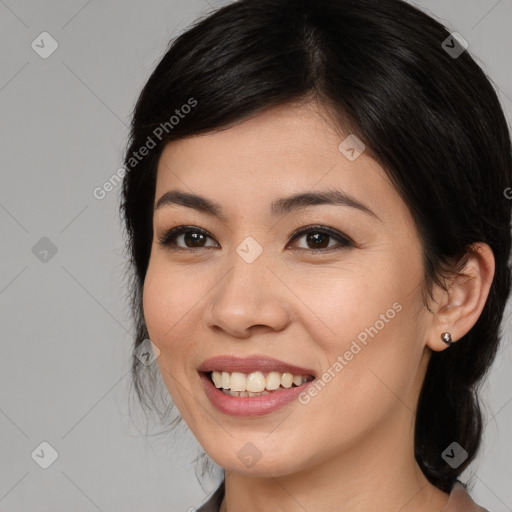 Joyful asian young-adult female with medium  black hair and brown eyes