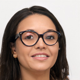 Joyful latino young-adult female with long  brown hair and brown eyes