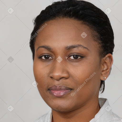 Joyful black young-adult female with short  black hair and brown eyes