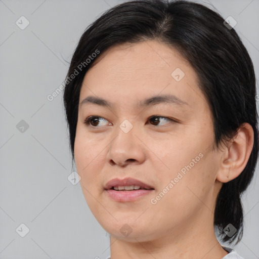 Joyful asian young-adult female with medium  black hair and brown eyes