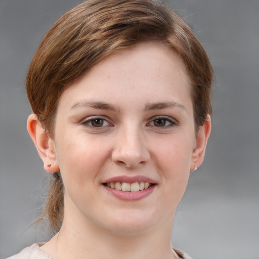 Joyful white young-adult female with short  brown hair and grey eyes