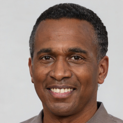 Joyful latino adult male with short  black hair and brown eyes
