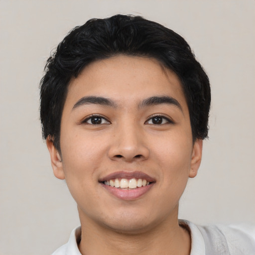 Joyful asian young-adult male with short  black hair and brown eyes