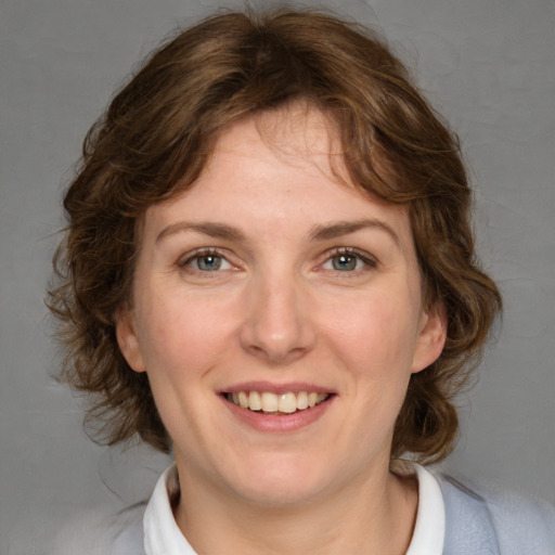 Joyful white young-adult female with medium  brown hair and blue eyes