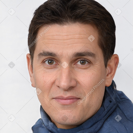 Joyful white adult male with short  brown hair and brown eyes