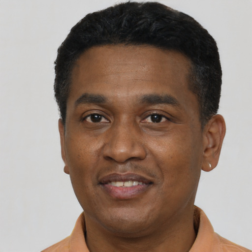 Joyful black young-adult male with short  black hair and brown eyes
