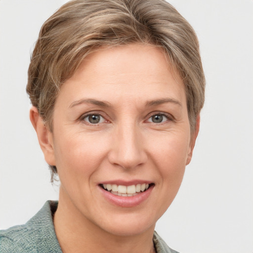 Joyful white adult female with short  brown hair and grey eyes