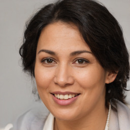 Joyful white adult female with medium  brown hair and brown eyes