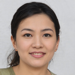 Joyful asian young-adult female with medium  brown hair and brown eyes