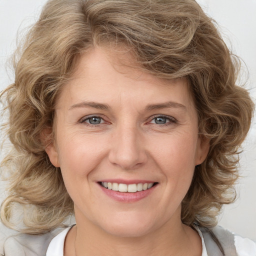 Joyful white young-adult female with medium  brown hair and blue eyes