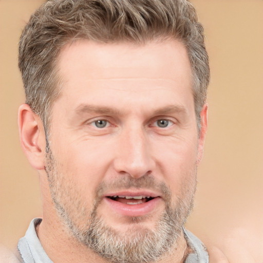 Joyful white adult male with short  brown hair and grey eyes